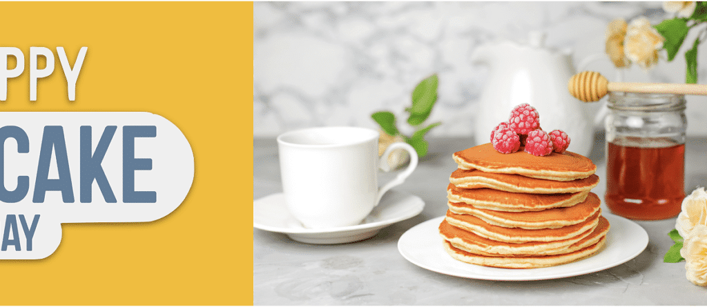 Happy pancake day with a stack of pancakes and a cup of coffee.
