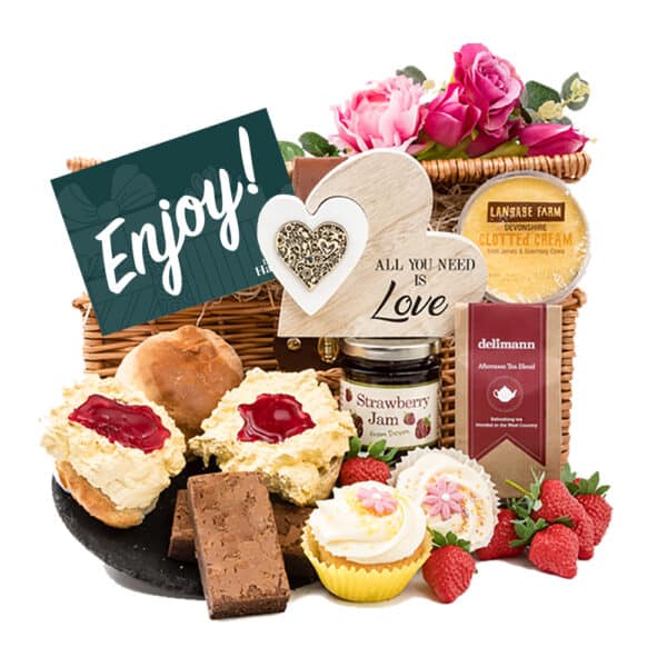 A wicker basket filled with sweet treats including Cupcake & an Anniversary Cream Tea, accompanied brownies and keepsake love heart