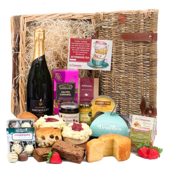 A wicker basket filled with Champagne and snacks for a luxurious Afternoon Tea.