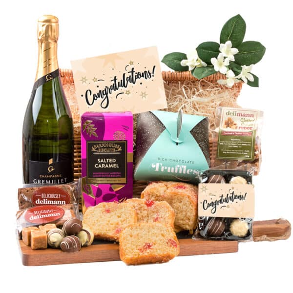 A celebratory gift basket with a bottle of Celebration Champagne Tea and chocolates.