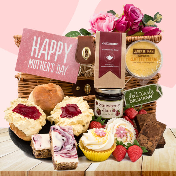 The Mother's Day Cupcake Cream Tea gift includes scones, clotted cream, strawberry jam, brownies, cupcakes, a "Happy Mother's Day" card in a wicker basket, perfect cream tea experience.