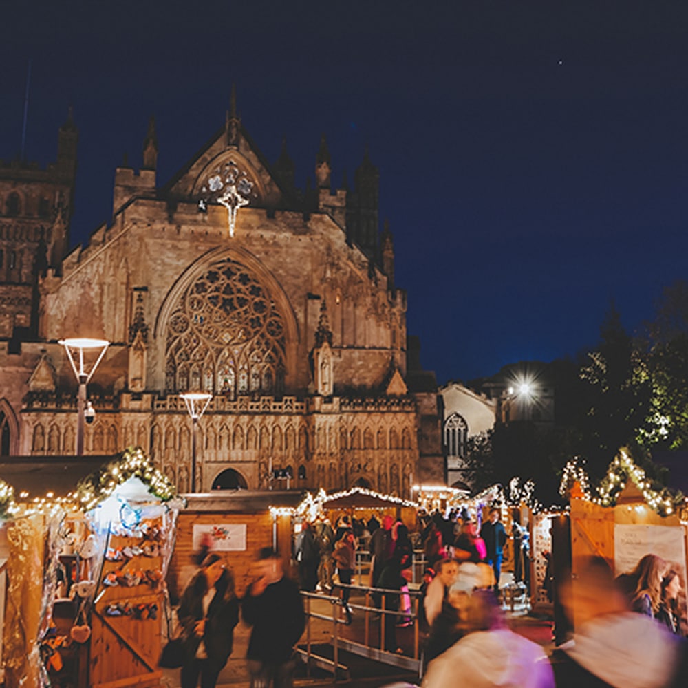 A christmas market in front of a Exeter cathedral.