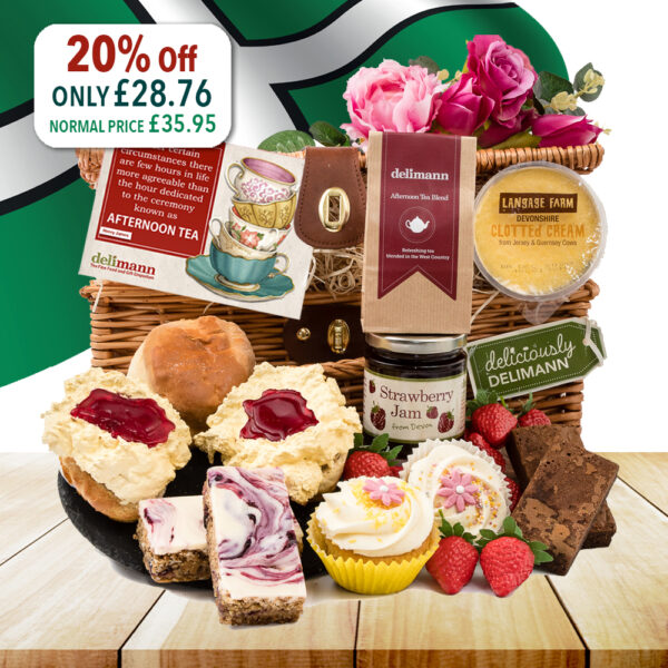 A wicker basket brimming with assorted treats, such as scones, clotted cream, jams, cupcakes, brownies, flapjacks and tea. A sign announces a 20% discount on The Devon Cupcake Afternoon Tea selection, reducing the price from £35.95 to £28.76.