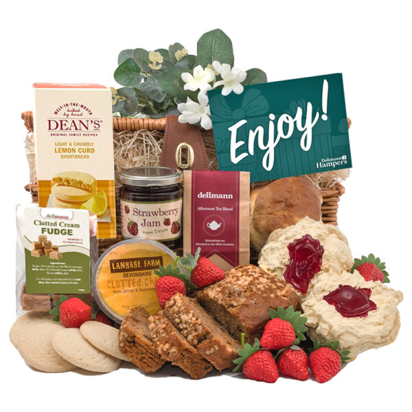 The Afternoon Tea & Treats Hamper includes a wicker basket filled with lemon curd, jam, fudge, scones, and delicious strawberry jam. A green "Enjoy!" card enhances this gourmet assortment.