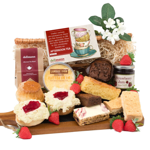 A Devon cream tea with assorted bakery goods like a brownie, muffin and flapjack.